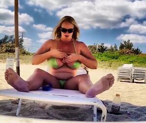 Round Cougar applies sunscreen to immense knockers